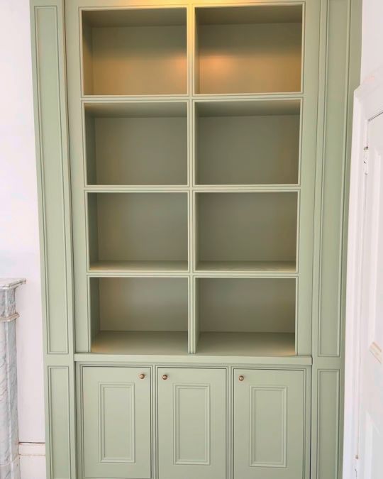 Fitted wooden alcove shelves and cupboard