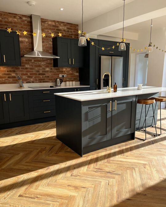 Shaker style kitchen with herringbone wooden flooring