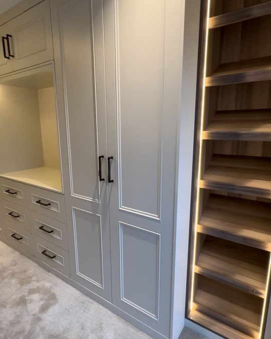 Fitted bedroom wardrobe with lighting and shelves